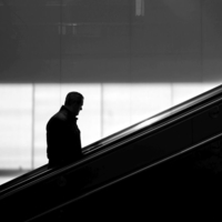 People in geometry of light and shadow at train stations