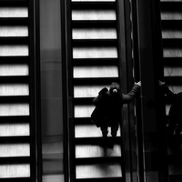 People in geometry of light and shadow at train stations