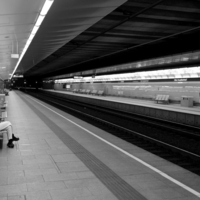 People in geometry of light and shadow at train stations