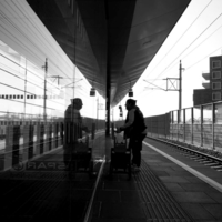 People in geometry of light and shadow at train stations