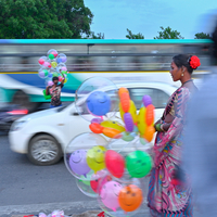 Amid the rush, She stands still — a quiet burst of color in a world that won’t slow down.