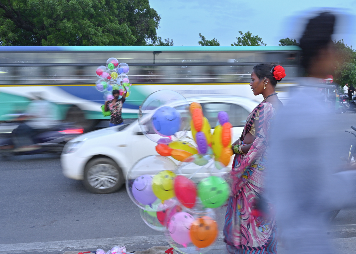 Amid the rush, She stands still — a quiet burst of color in a world that won’t slow down.