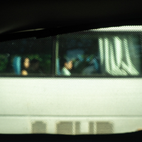 Bus in a taxi window frame